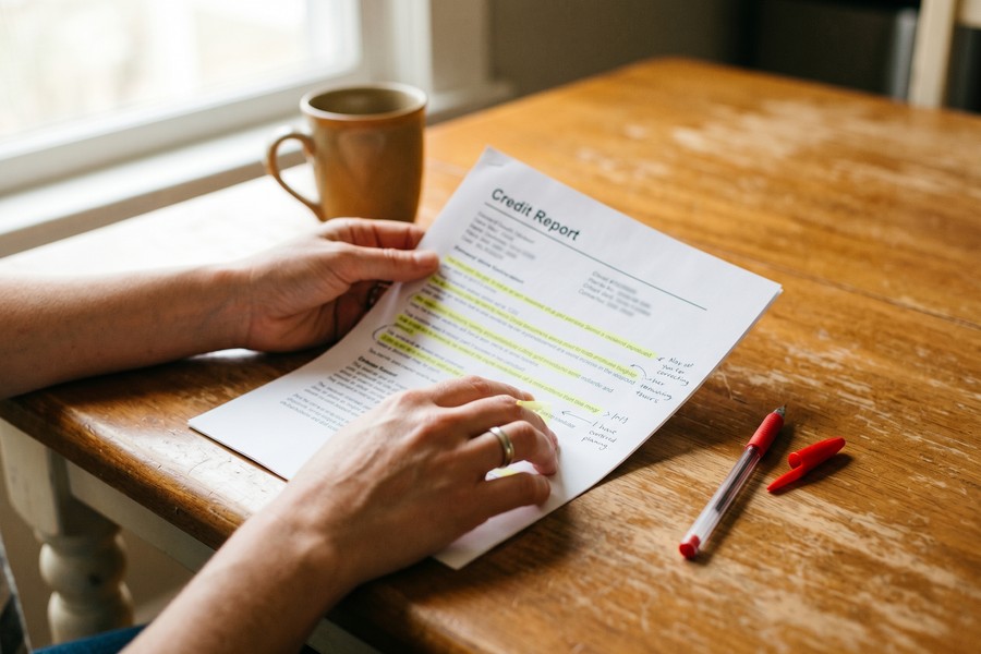 Borrower reviewing loan application documents and comparing two lender offer letters